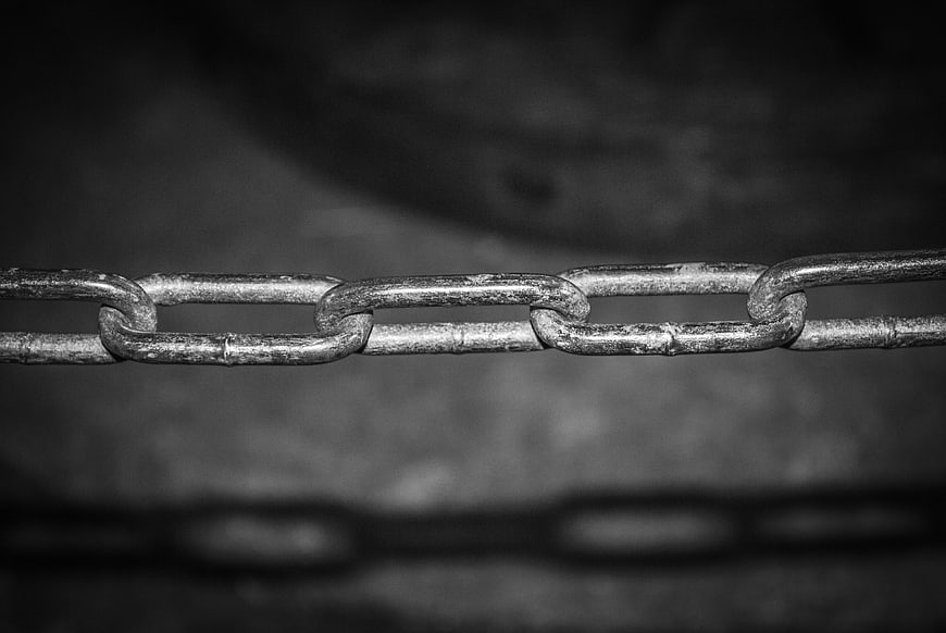 Close-up of metal chain links with shadow