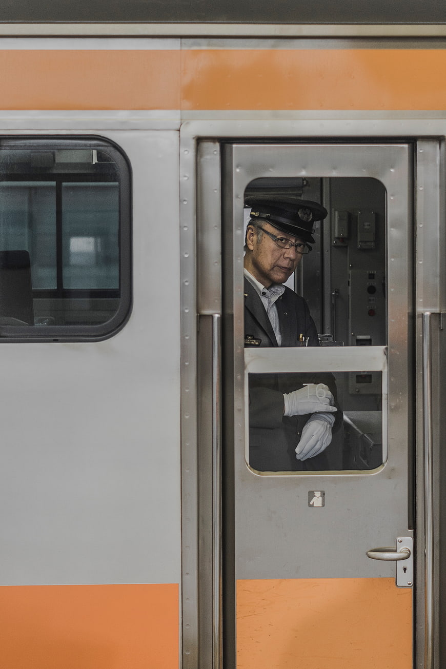 Train conductor looking out from the cabin door window