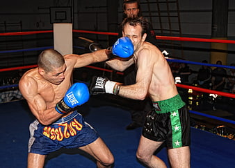 Intense Boxing Match in Ring with Blue and Black Gloves