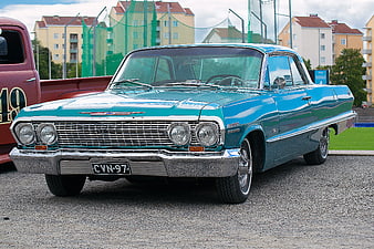 Classic Teal Chevrolet Impala Parked on Asphalt