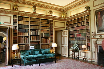 Historic Castle Library Interior With Green Velvet Sofa And Bookshelves