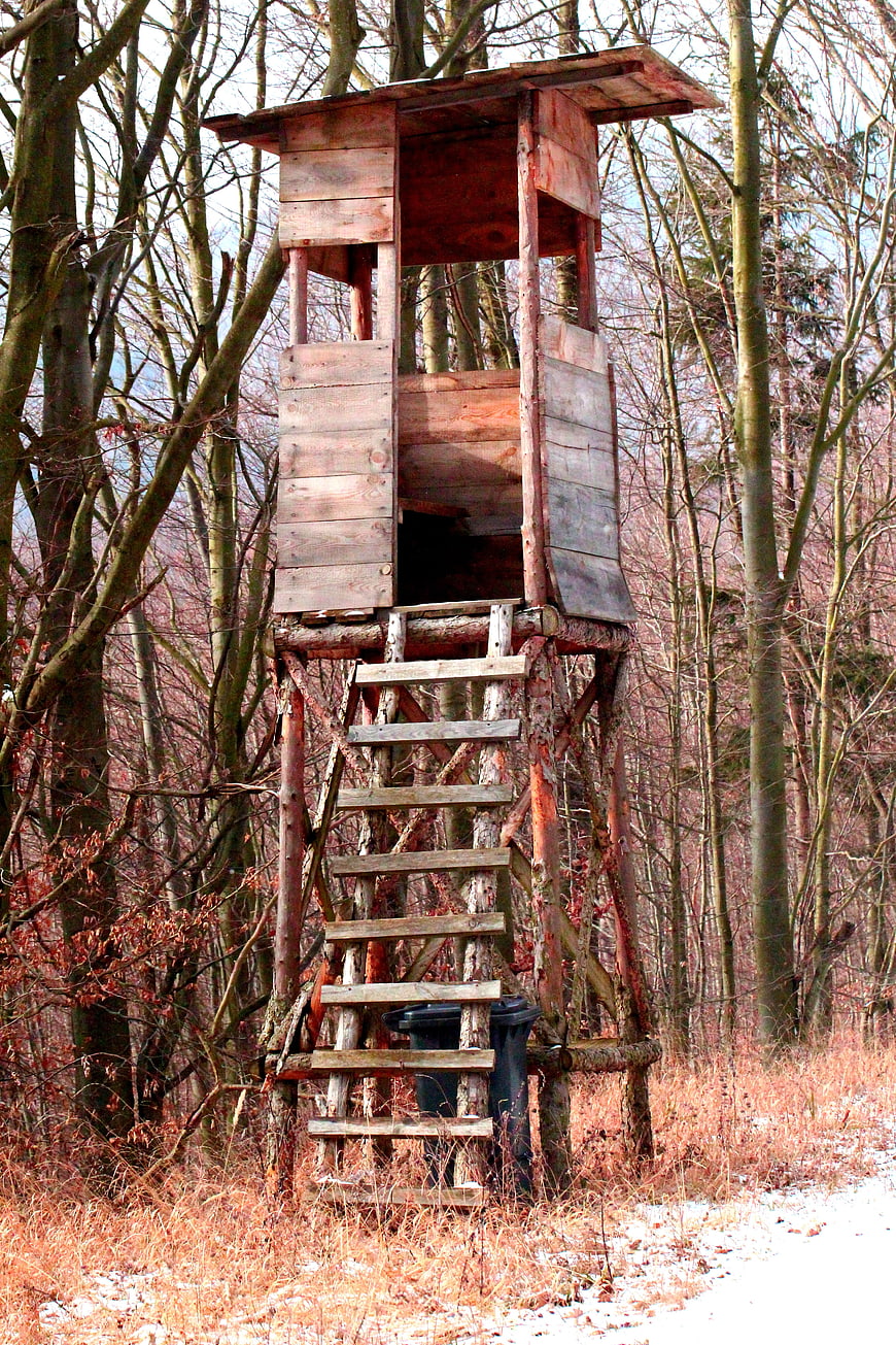 Rustic wooden hunting stand in winter forest