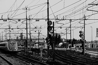 Black and white high-speed train on railway tracks