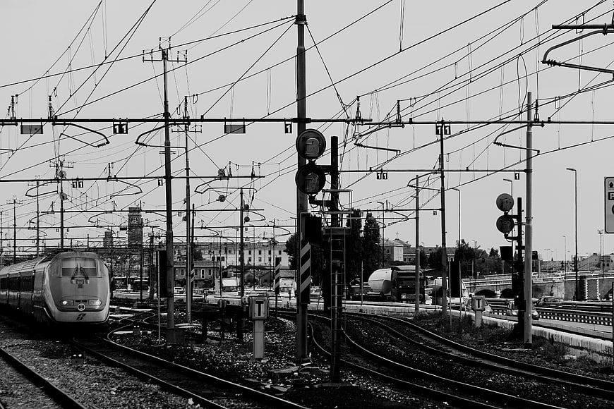 Black and white high-speed train on railway tracks