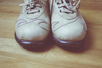 Vintage beige leather shoes on wooden floor