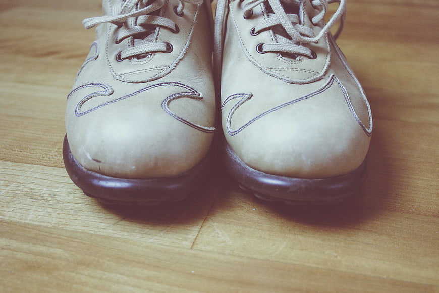 Vintage beige leather shoes on wooden floor