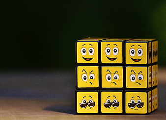 Rubik's Cube with Emoji Faces Showing Different Emotions
