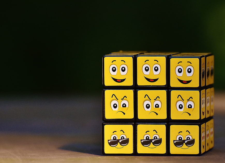 Rubik's Cube with Emoji Faces Showing Different Emotions