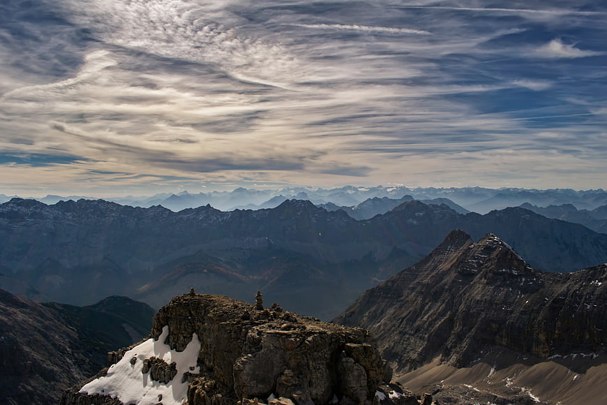 Majestic Alpine Mountain Range with Rocky Summit and Cloudy Sky