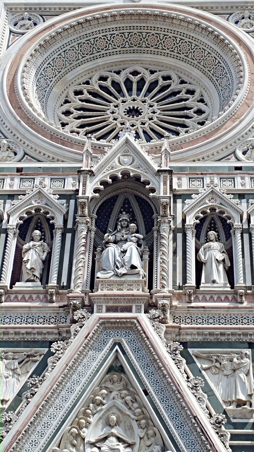 Detailed facade of Florence Cathedral with rose window and statues