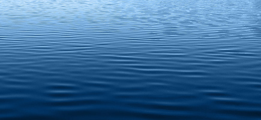 Calm Blue Water Surface Texture With Gentle Ripples