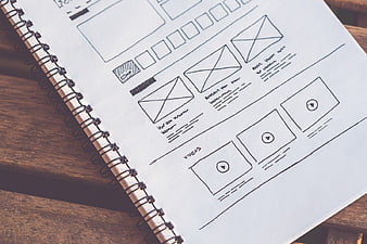 Hand-drawn website wireframe sketch on notebook