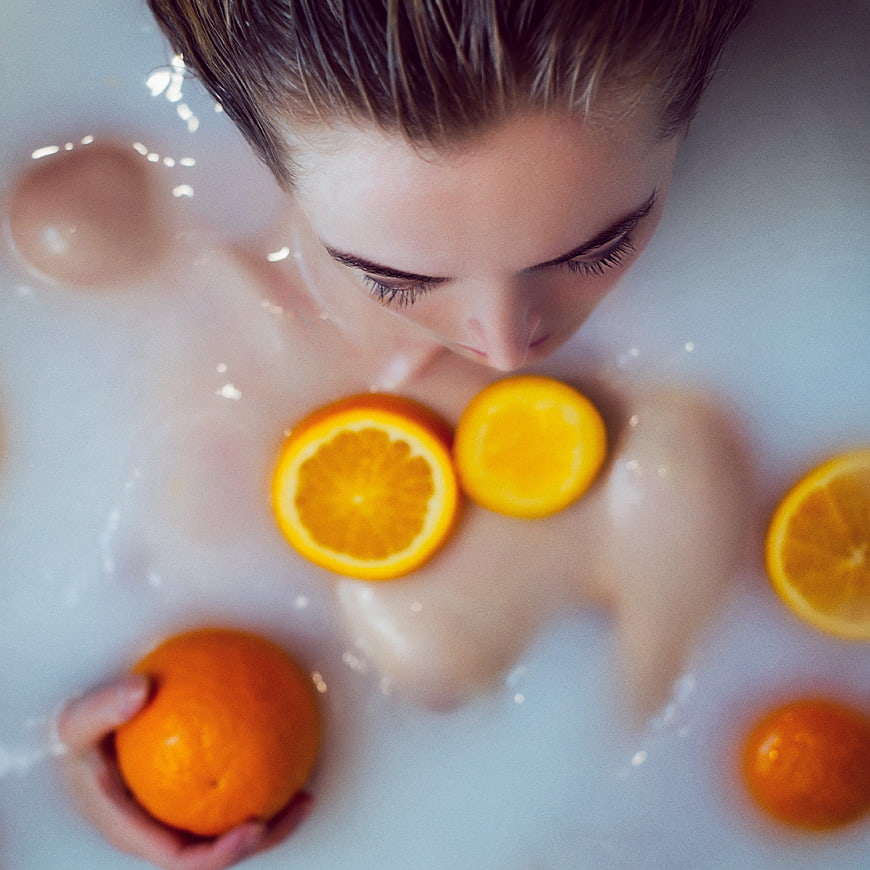 Woman in Milk Bath with Oranges