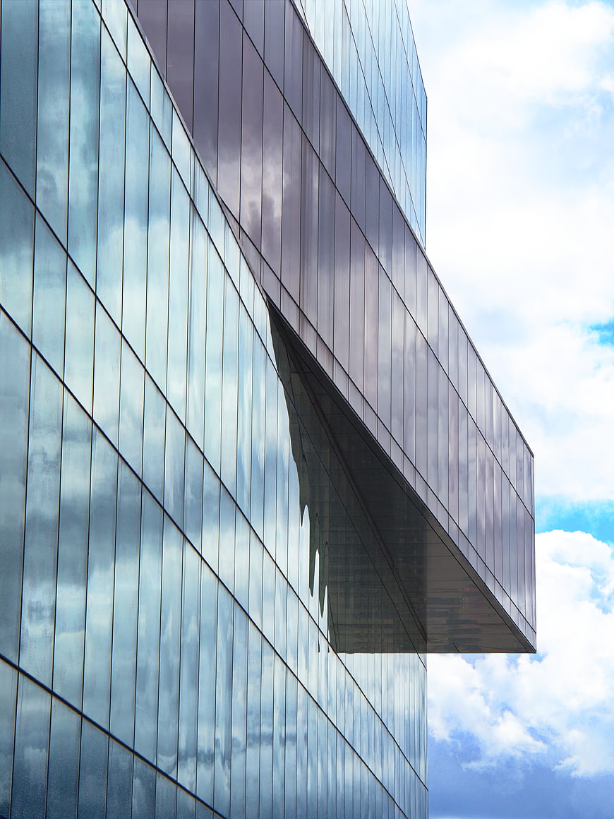 Modern Glass Office Building Facade with Sky Reflection