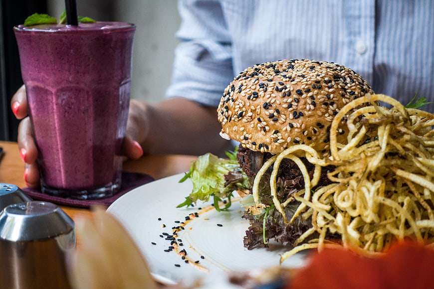 Vegan Burger with Onion Strings and Purple Smoothie