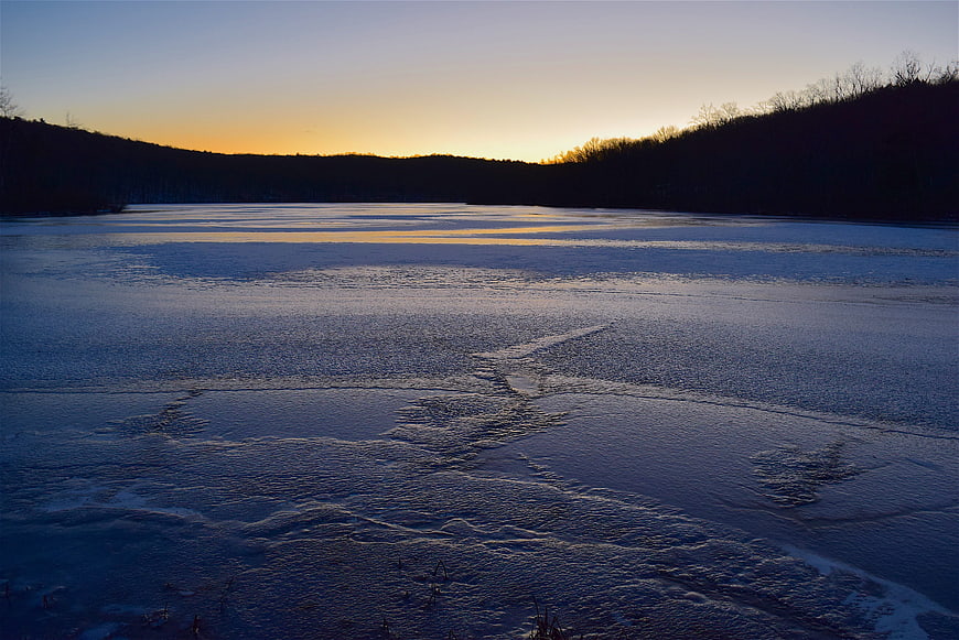Frozen Lake Landscape at Sunset with Golden Horizon