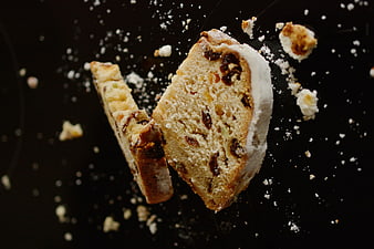 Slices of Christmas Cake with Powdered Sugar on Black Background