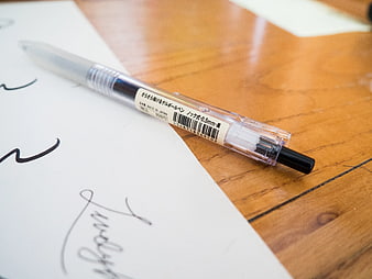 Clear Gel Pen on Wooden Desk with Signature