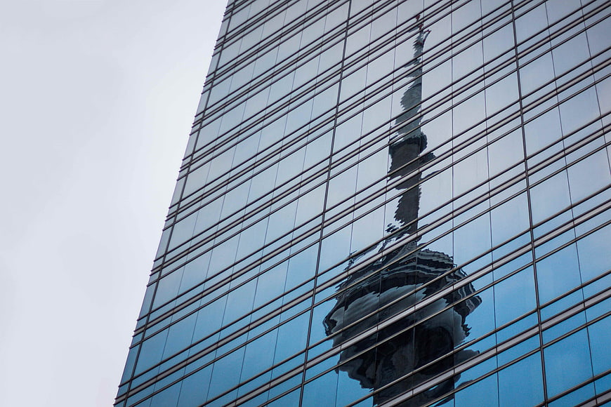 Reflection of CN Tower on Glass Skyscraper Facade