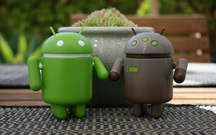 Green and Gray Android Robot Figurines on Woven Mat