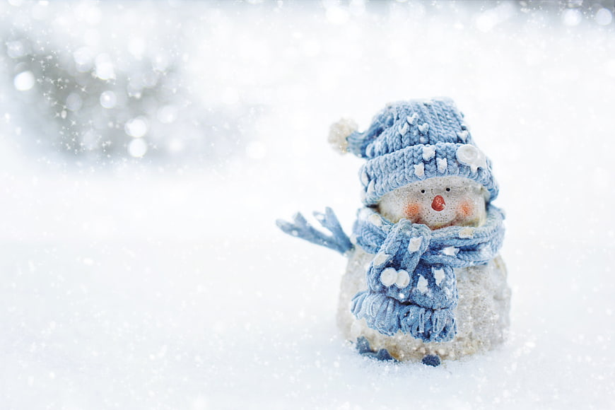 Cute Miniature Snowman in Blue Knit Hat and Scarf