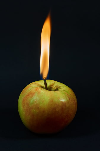 Burning Apple Candle Still Life On Black Background
