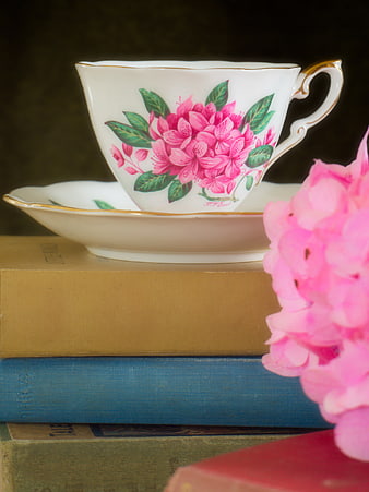 Vintage Floral Teacup on Stack of Old Books
