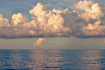 Dramatic Clouds Over Calm Ocean at Sunset