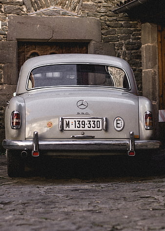 Vintage Silver Mercedes-Benz 220 Rear View on Cobblestone