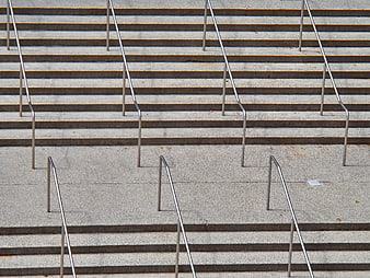Minimalist concrete stairs with metal railings pattern