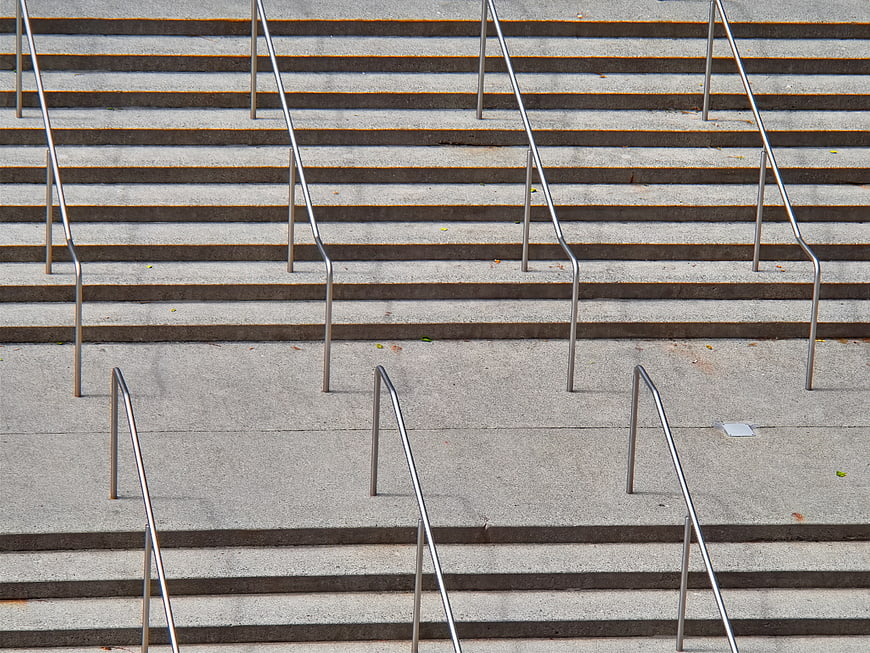 Minimalist concrete stairs with metal railings pattern