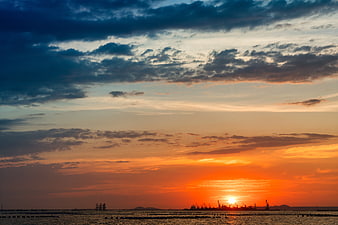 Dramatic Sunset Over Industrial Port Horizon