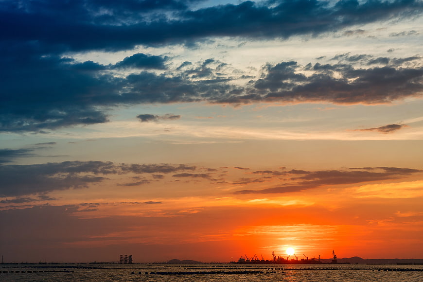 Dramatic Sunset Over Industrial Port Horizon