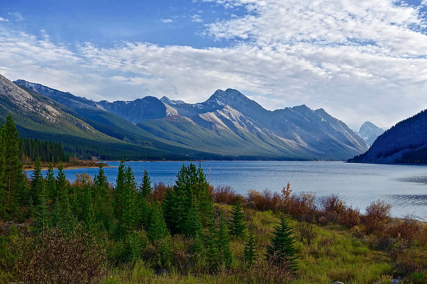 Scenic Mountain Lake with Pine Forest and Blue Sky