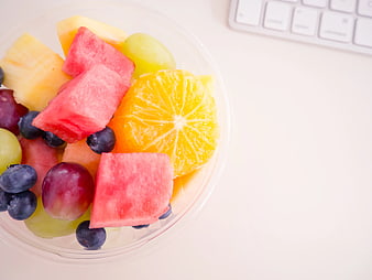 Fresh Fruit Salad in Clear Cup on White Desk