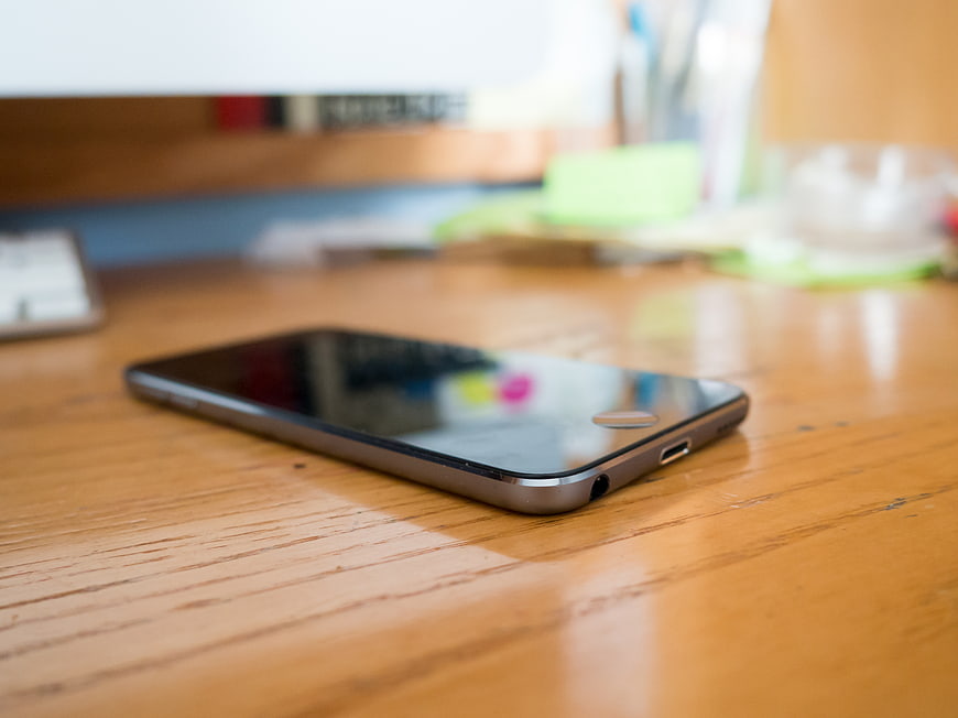 Smartphone on Wooden Desk in Office Workspace