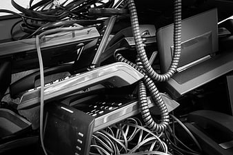 Pile of discarded old office telephones and tangled coiled cords