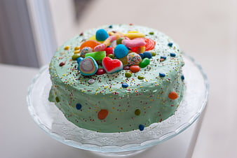 Colorful Mint Cake with Candy Toppings on Glass Stand