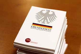 Stack of German Basic Law Books on Wooden Table