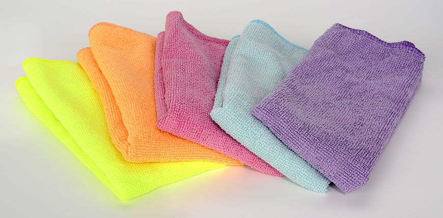 Stack of colorful microfiber cleaning cloths on white background