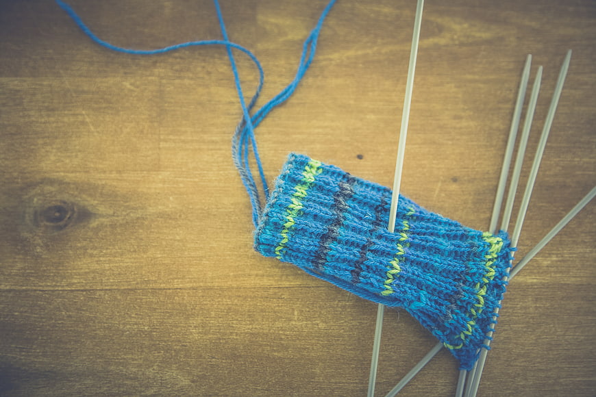 Blue Knitting Project in Progress on Wooden Table