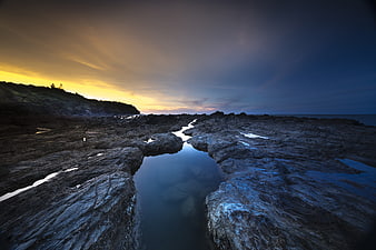 Dramatic Rocky Coastline at Sunset with Tide Pools