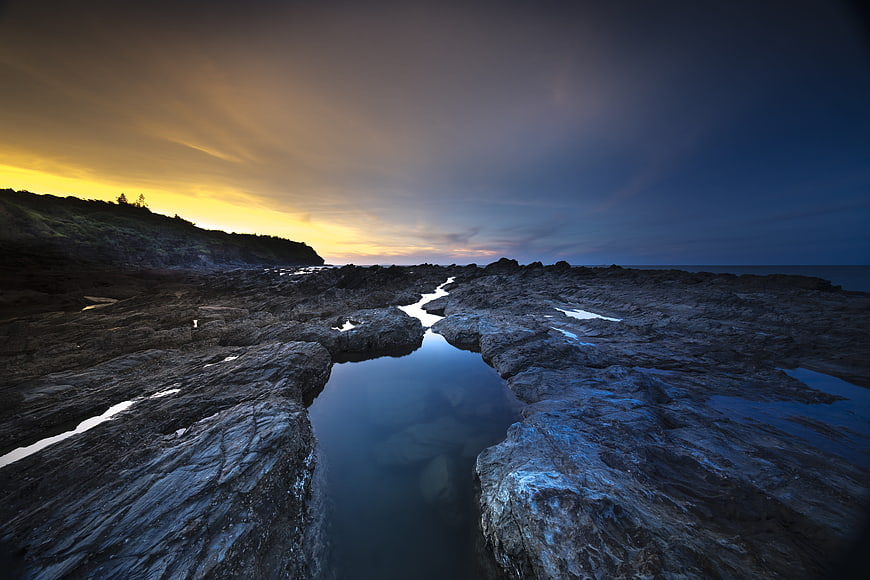 Dramatic Rocky Coastline at Sunset with Tide Pools