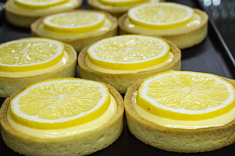 Fresh Lemon Tarts with Glazed Slices on Dark Tray