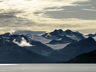 Snow-Capped Mountains and Glaciers Over Calm Water