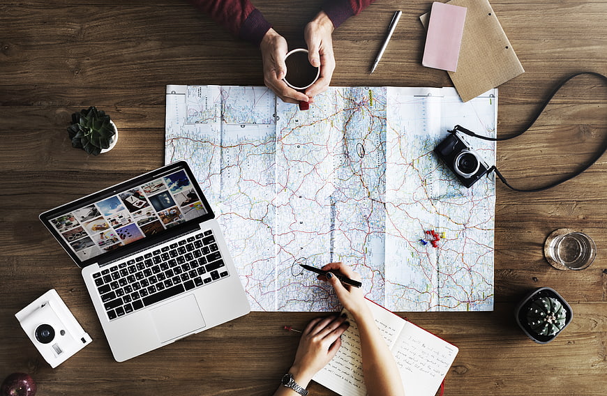 Top View Travel Planning with Map and Laptop