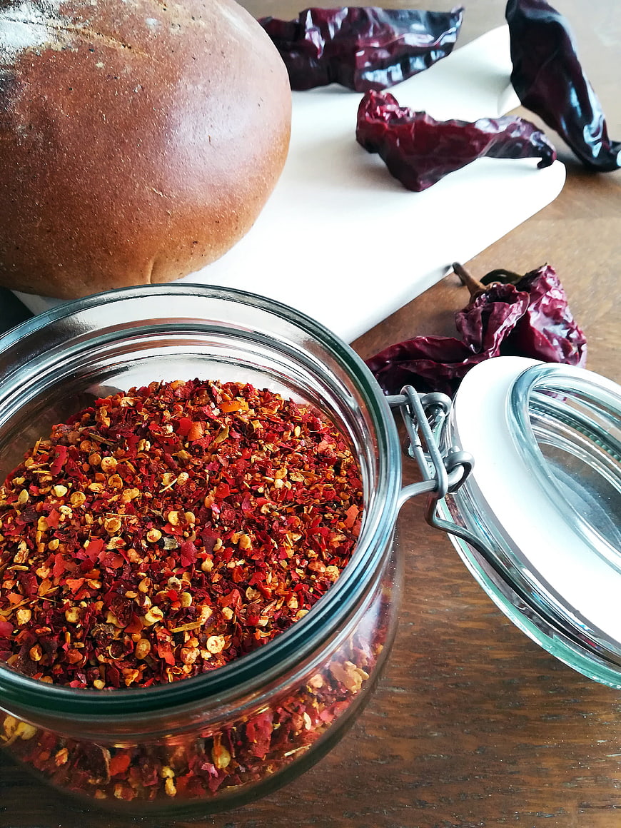 Jar of Crushed Red Pepper Flakes with Bread