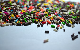 Colorful Chocolate Sprinkles Scattered On White Surface