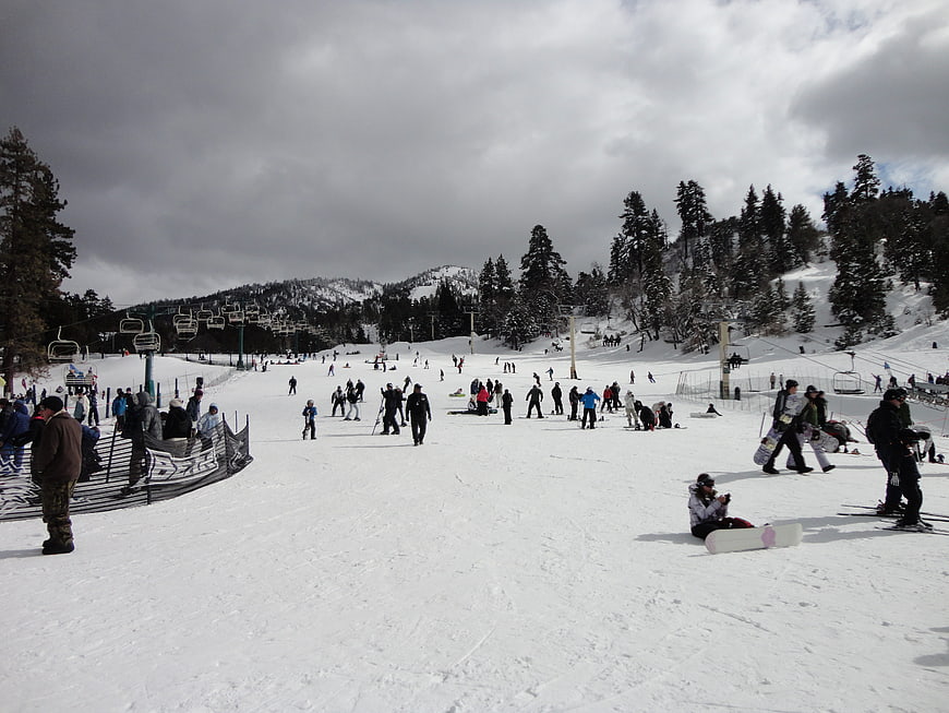 Busy ski resort slope with skiers and snowboarders