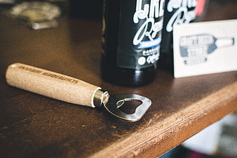Wooden Handle Bottle Opener on Rustic Table